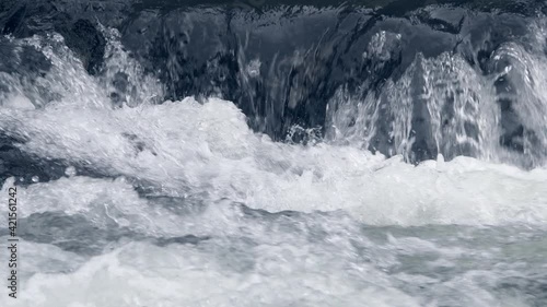 Wallpaper Mural Turbulent water flow closeup. River splashes and foams in shallows. Creek glistens as it runs down rocks. Spring stream after rain waves rolls over stones. Torontodigital.ca