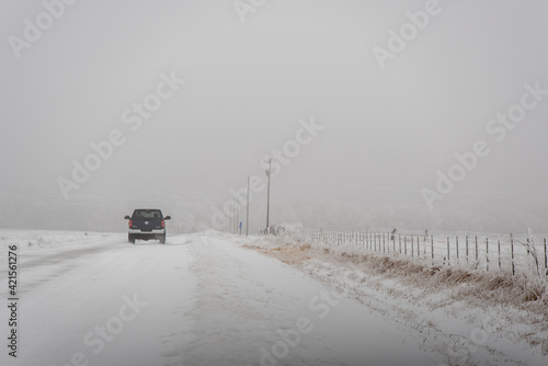 car in snow on a gravel road