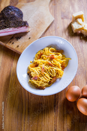 Spaghetti carbonara with egg  parmesan cheese and guanciale meat. Ingredients for fresh carbonara pasta. Spaghetti carbonara. Italian recipe. Fresh food. Macro Food Photography. Close Up