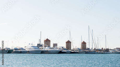 Rhodes harbor with three windmills and many yachts. Dodecanese, Greece