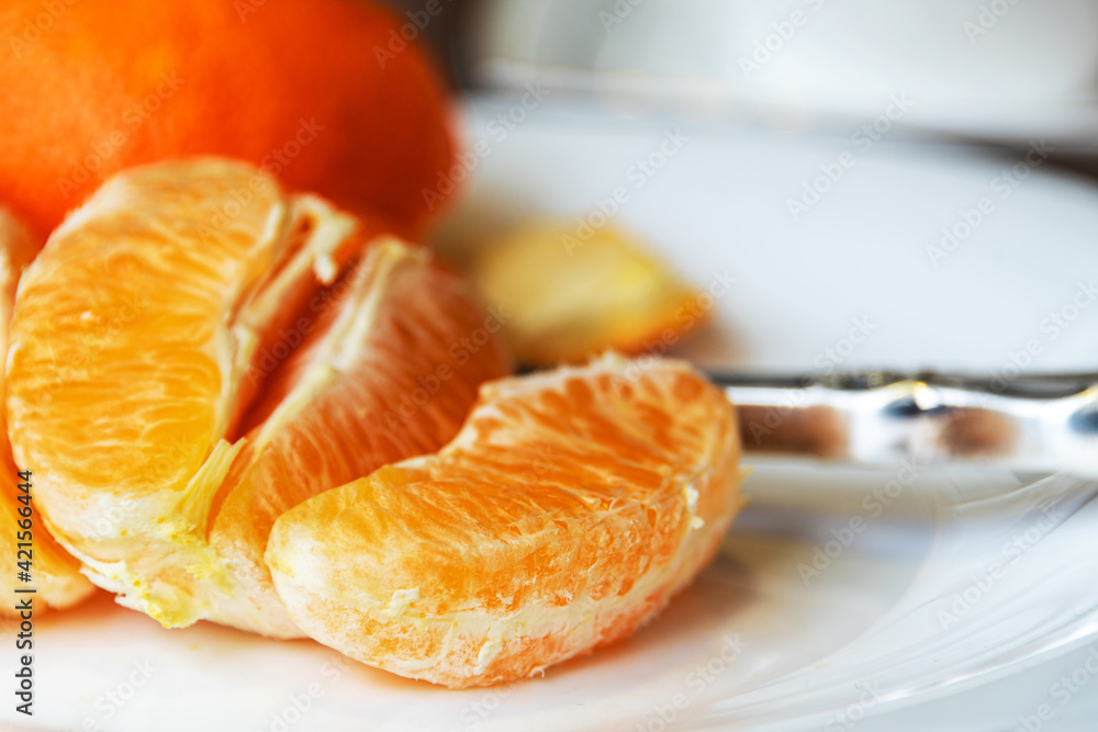 Orange slices on a white plate. Selective focus. Close-up. Orange slices on a white plate. Selective focus. Close-up.