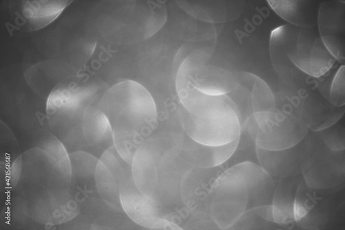 Black and white bokeh blurred background, silver blur desfocused abstract shapes, Christmas 2022 and 2023