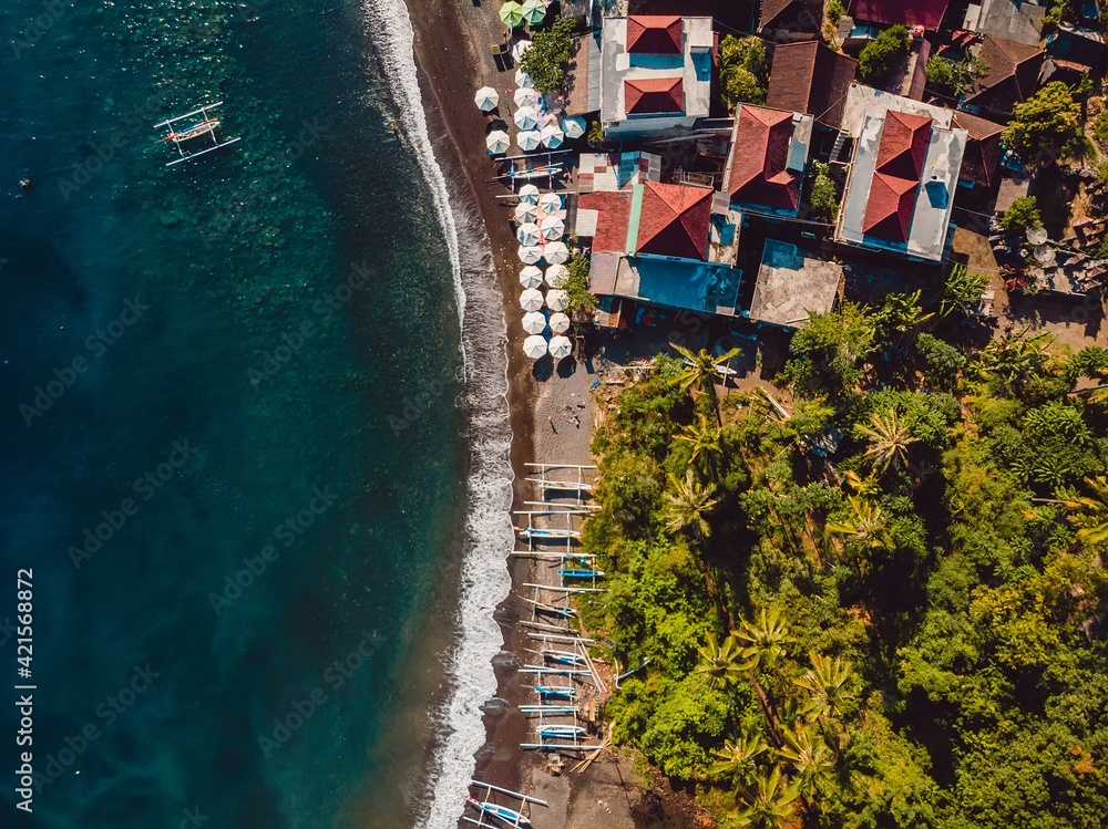 Aerial view of village with sea and boats in Bali, Amed.