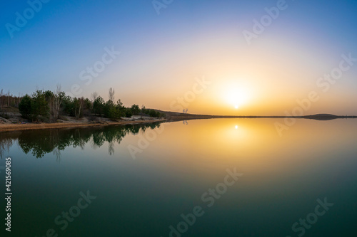 Beautiful sunset at a lake with a calm water surface
