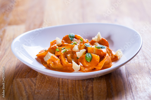 Delicious tortellini pasta in red tomato sauce with basil and parmesan cheese.
Tortellini pasta on white plare. Fine dish. Italian food
Home made fresh tortelini