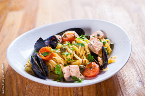 Pasta with seafood. Pasta with mussels and basil. Fresh Seafood fresh homemade pasta with mussels and parsley. Fresh Italian food. Mediterranean fresh sea food dish. Beautiful plate. fine dish