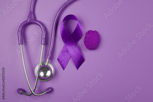 Purple day. World epilepsy day. Purple ribbon on purple background photo