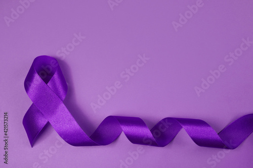Purple day. World epilepsy day. Purple ribbon on purple background photo