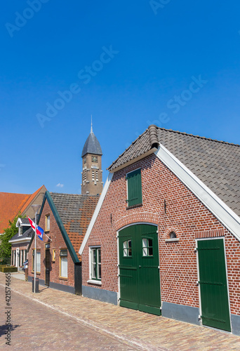 Street with old houses and church tower in Rijssen, Netherlands photo