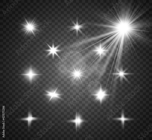 Set of bright beautiful stars. Light effect. Bright Star. Beautiful light to illustrate. Christmas star. White glitter sparkles with special light effect. Vector sparkles on a transparent background.