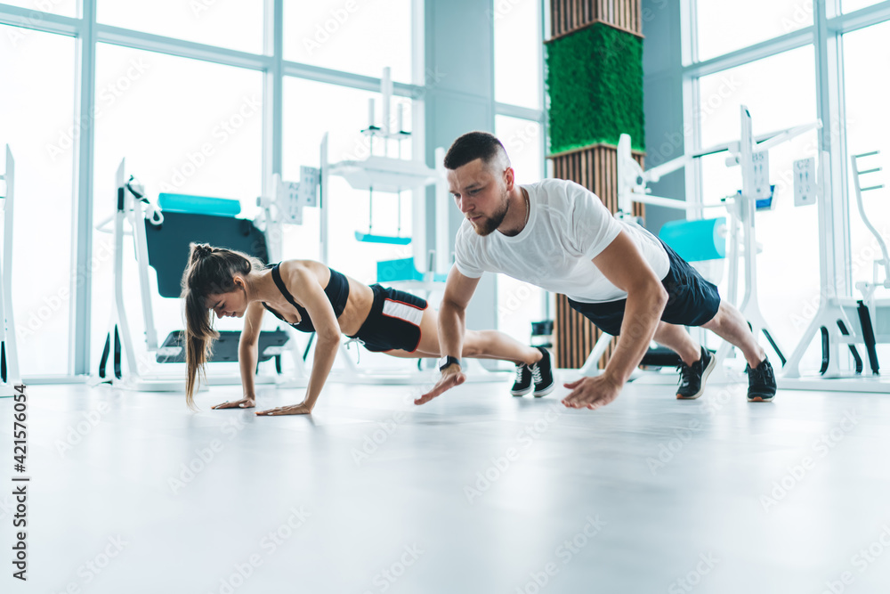 Young sporty couple doing push ups