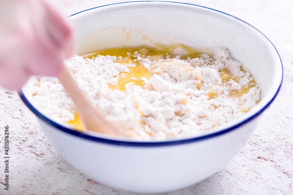Making a shortcrust pastry adding melted butter to the flour Making a shortcrust pastry adding melted butter to the flour