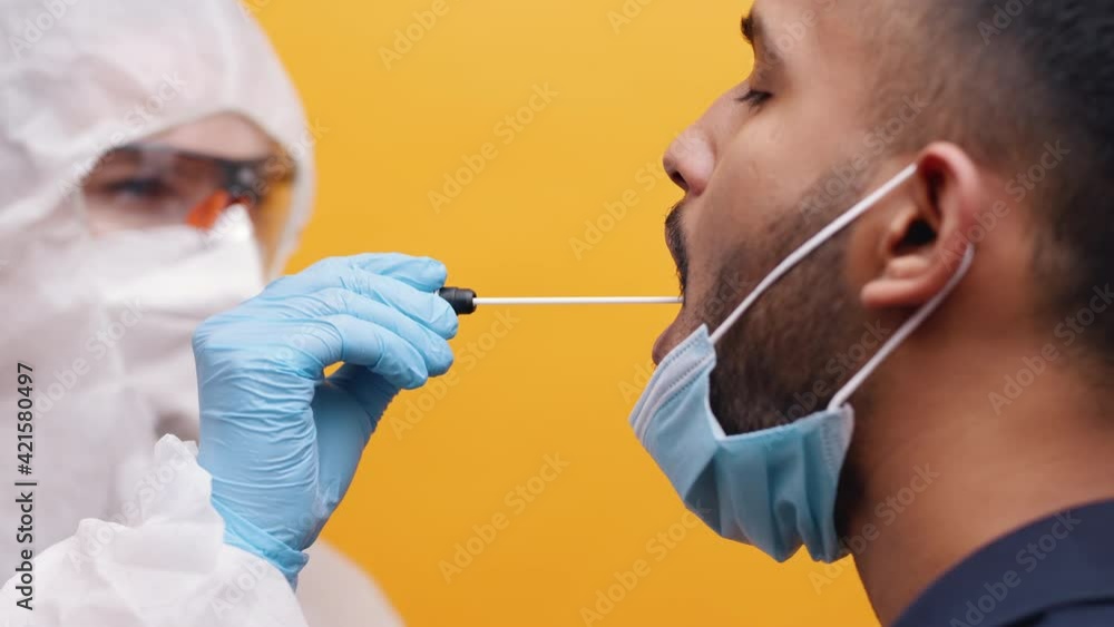 Nurse performing covid 19 swab test on indian man. High quality 4k footage Nurse performing covid 19 swab test on indian man. High quality 4k footage