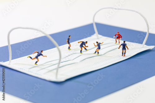 Football training on a Facemask, as illustrated by a miniature diorama