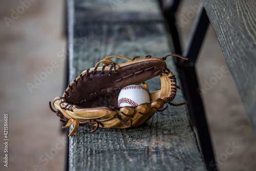 Empty dug out bench at a baseball field.