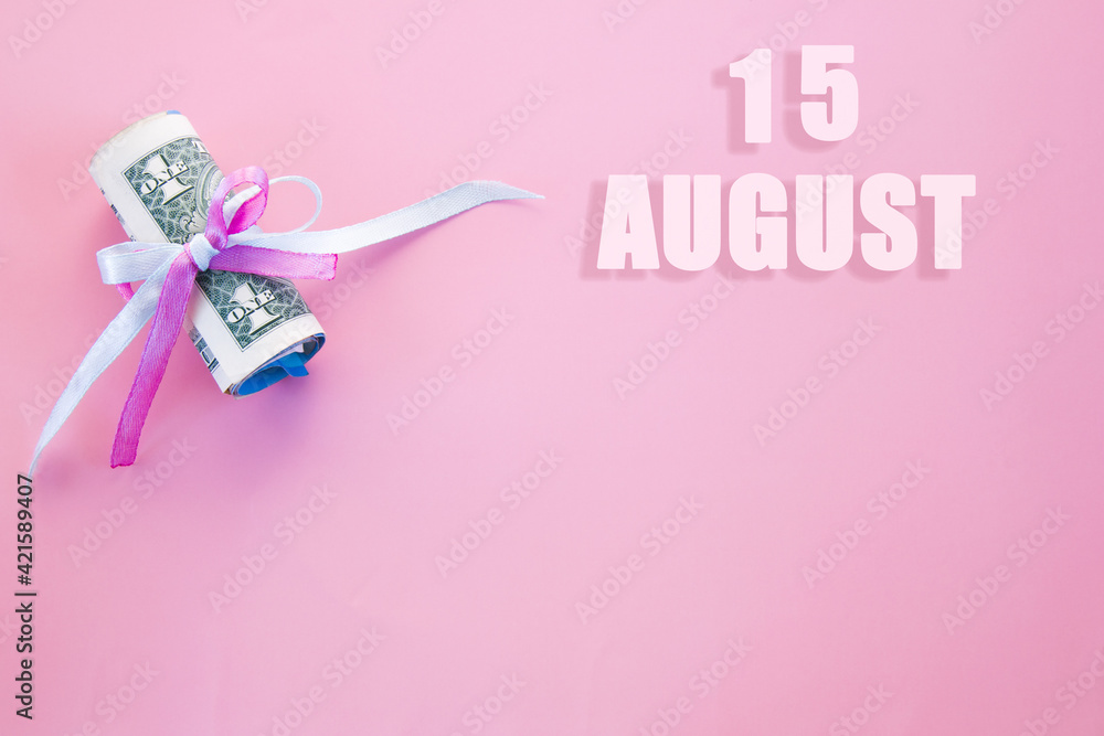 calendar date on pink background with rolled up dollar bills pinned by pink and blue ribbon with copy space. August 15 is the fifteenth day of the month
