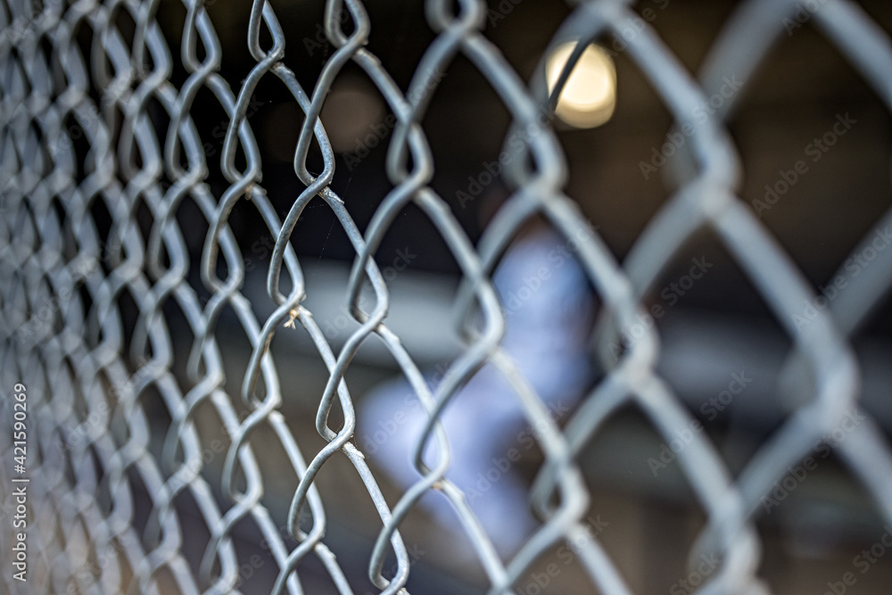 a chain link fence at a baseball dugout field a chain link fence at a baseball dugout field