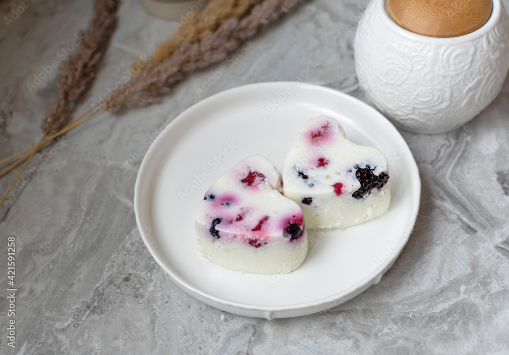 Panna Cotta with fresh berries on white plate. Delicious homemade dessert as tasty breakfast Panna Cotta with fresh berries on white plate. Delicious homemade dessert as tasty breakfast