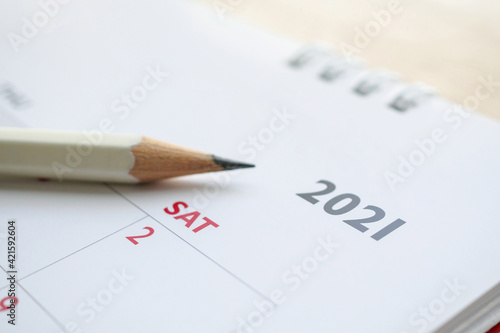 white pencil on 2021 calendar background business planning appointment meeting concept