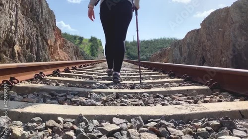 Person hiking along the railway track on the Alcolea bridge. photo