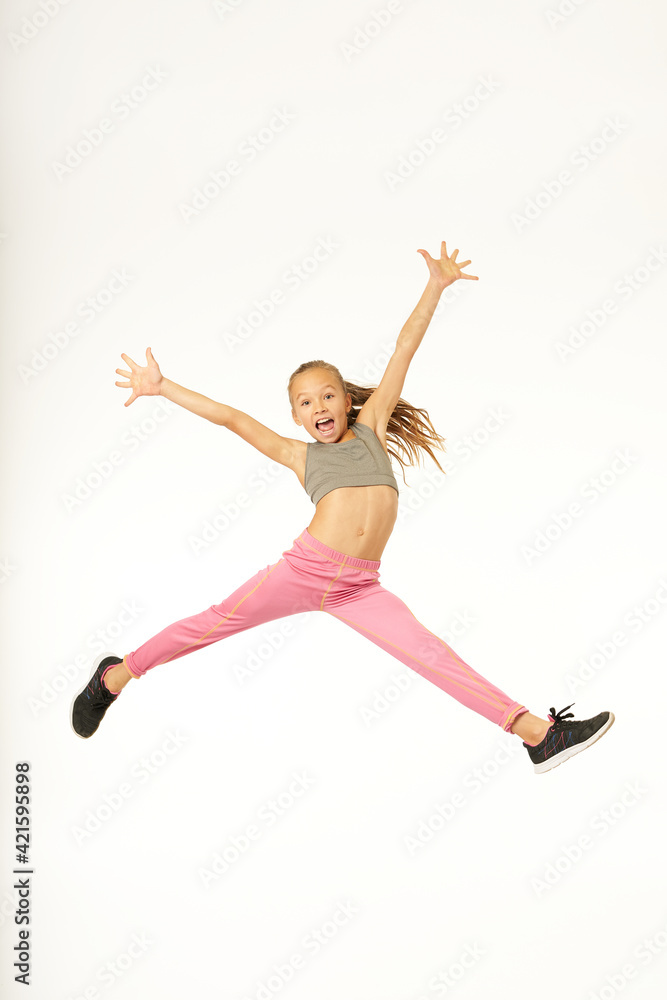 Cheerful cute girl jumping and screaming with joy