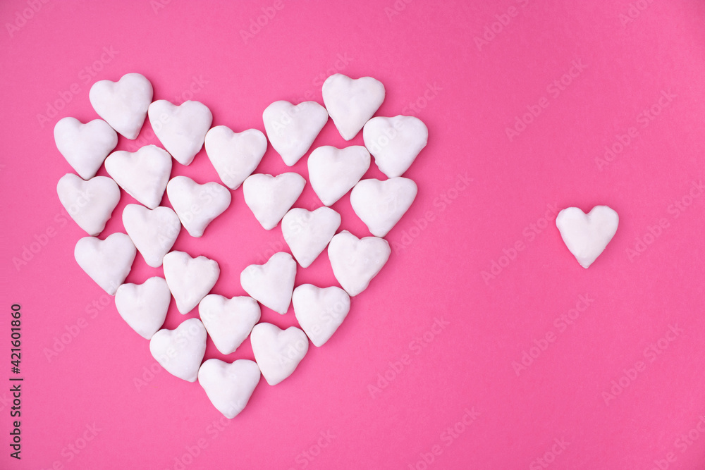Love concept idea with big heart made from small white hearts on pink background. Minimal flat lay.
