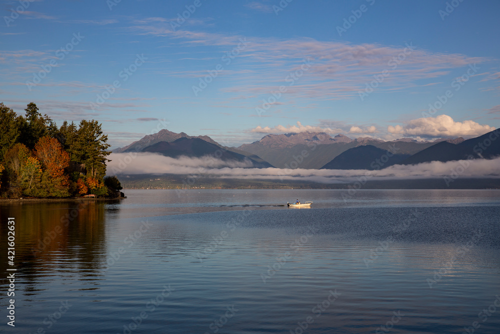 USA, Washington State, Seabeck. Fishing on Hood Canal with Olympic Mountains in the background.
