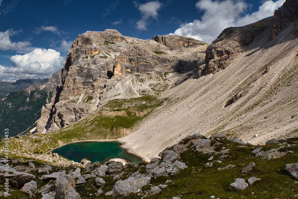 View of the Dolomites mountains with a colorful turquoise alpine lake