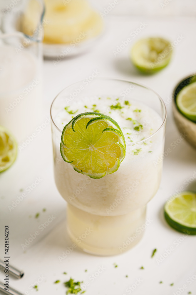 fresh lime juice, lime zest and pineapple. Served in a glass and garnished with a slice of lime. fresh lime juice, lime zest and pineapple. Served in a glass and garnished with a slice of lime.