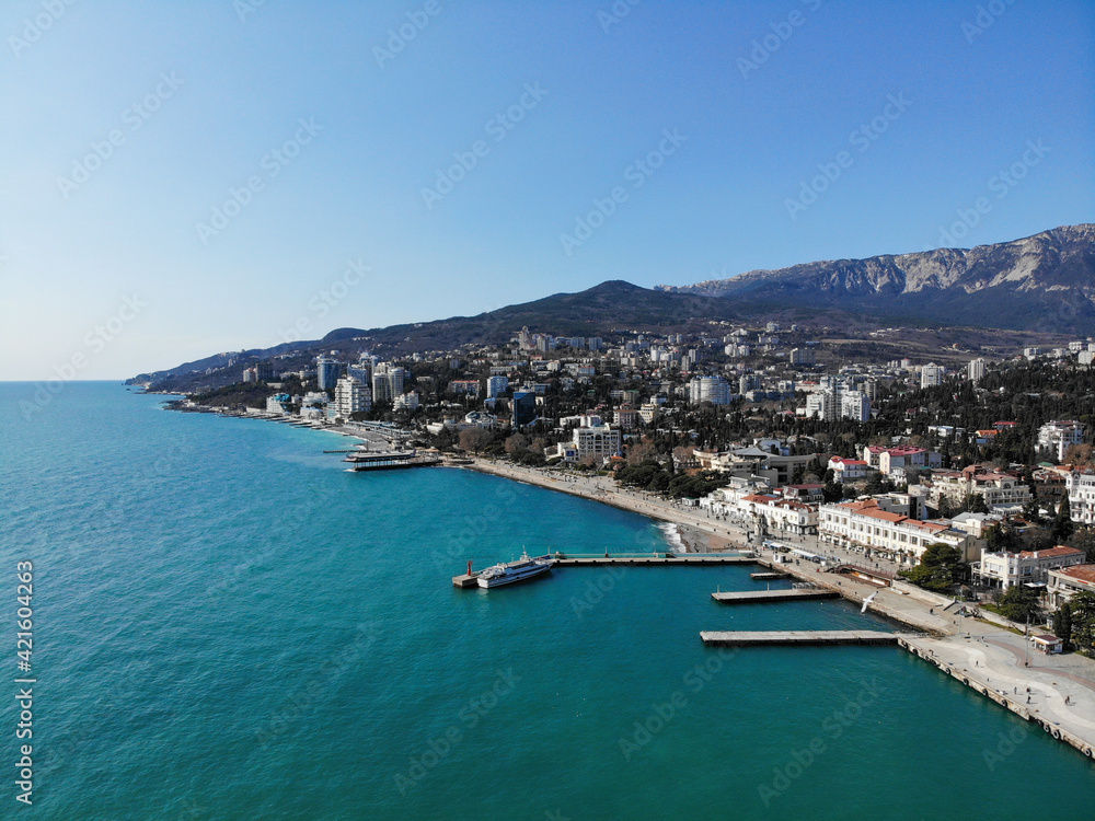 Embankment of the city of Yalta, Crimea on sunny spring day sea view. Photo made by drone from above