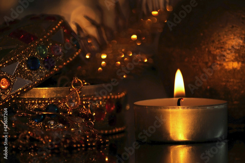 Golden candle and box with gold and jewelry, Luxury christmas decoration, happy new year 2022 and 2023,furtune telling and magic, warm cozy interior,  blured background