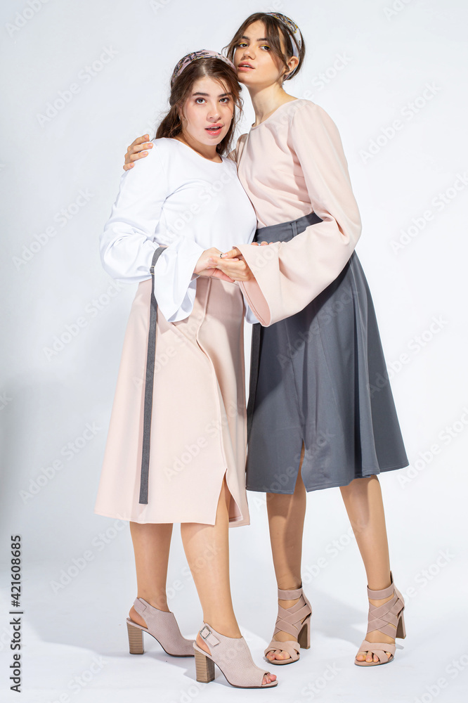 Young white girls isolated on light grey Young white girls isolated on light grey