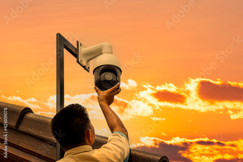 Technician installed CCTV Controlled speed dome PTZ camera in outdoors