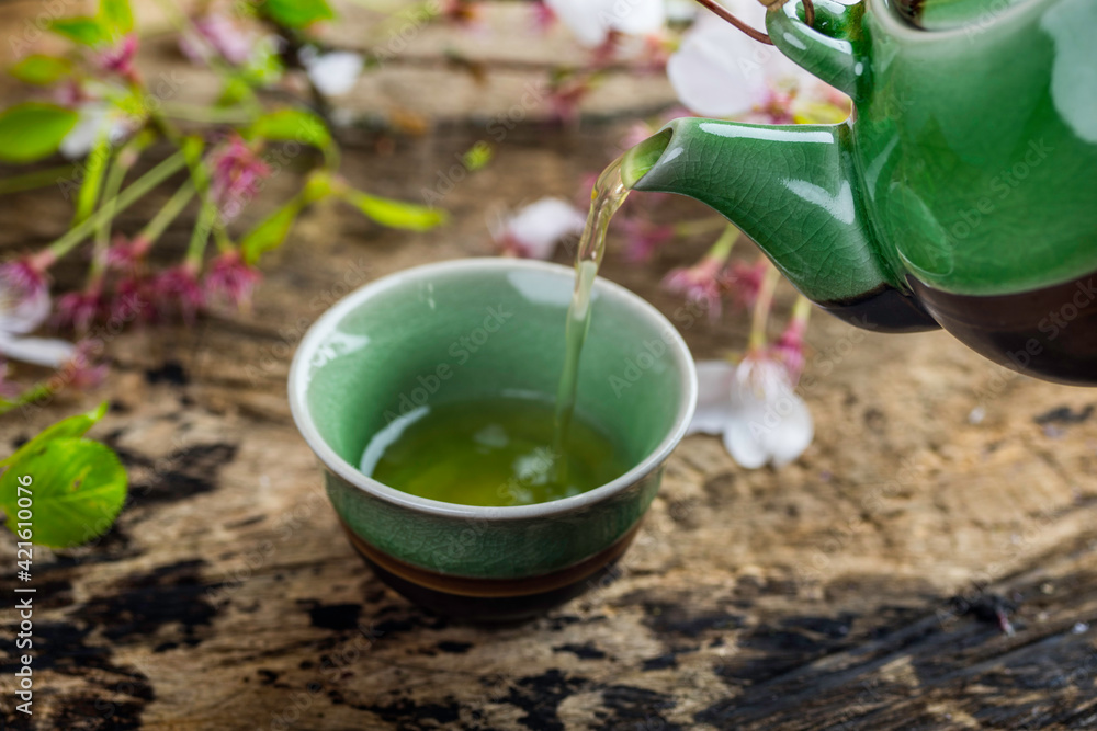 Green Tea pouring from green ceramic cattle Green Tea pouring from green ceramic cattle