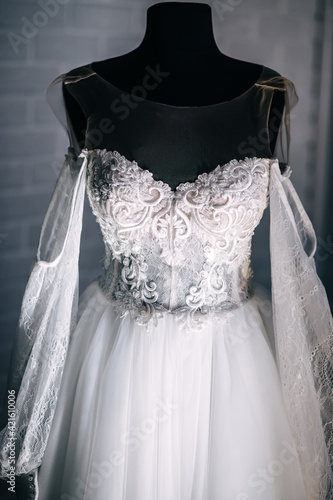 Luxurious fashionable beautiful white wedding dress with a corset, decorated with lace, crystals.