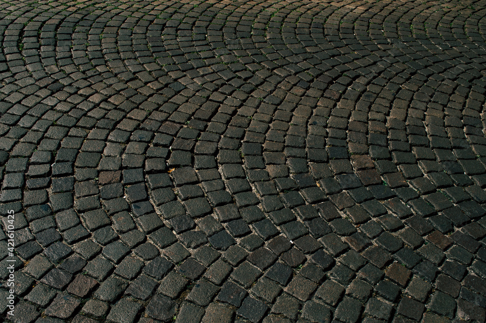 The road is made of stone in a semicircle