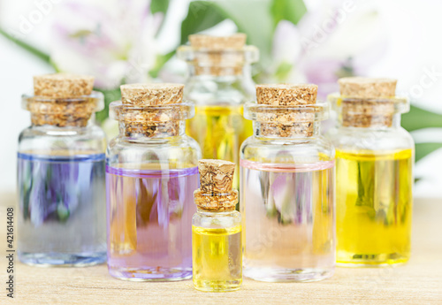 Set of colorful bottles with floral essential oil. Alternative medical concept.