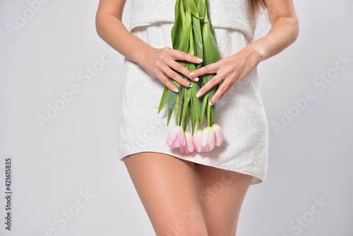Tableau sur toile Woman holding tulips in crotch area , intimate hygiene concept