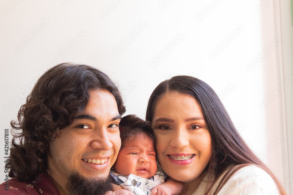 beautiful portrait of a heterosexual couple loving their newborn baby beautiful portrait of a heterosexual couple loving their newborn baby