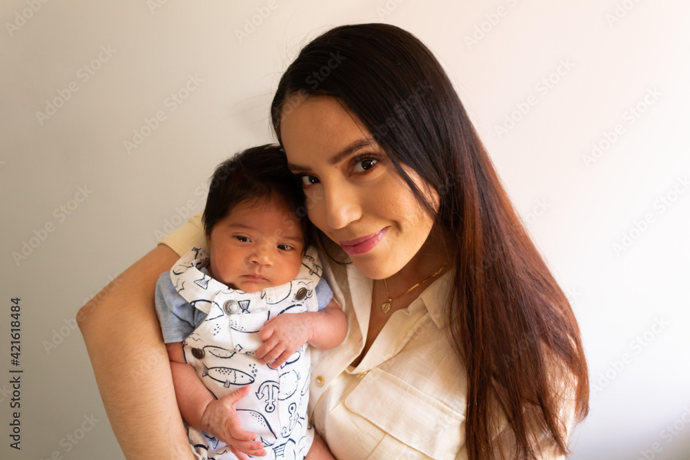beautiful portrait of a young hispanic mother with her newborn baby beautiful portrait of a young hispanic mother with her newborn baby