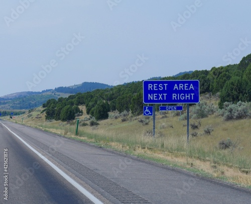 Roadside sign with directions to a rest area along the road in Utah.
