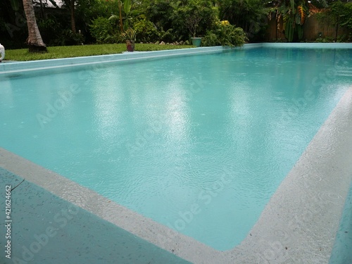 Side view, close up shot of a wwimming pool with clear waters at the Hemingway House in Key West, Florida. © raksyBH