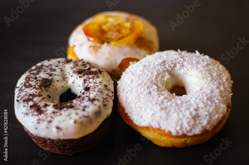 Three delicious Donuts on a black background