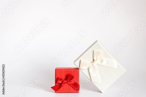 Craft gift box on a white background, decorated with a bow. For birthday, anniversary presents, gift post cards.