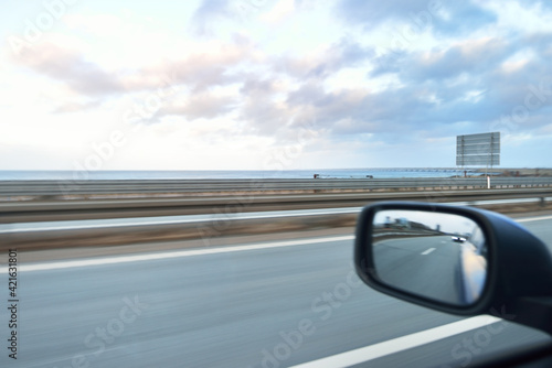 Highway and road bridge at sunset. European route E20. Dramatic sky. View from the car. Concept urban landscape. Travel destinations, road trip, logistics, transit, engineering. Scandinavia, Europe photo