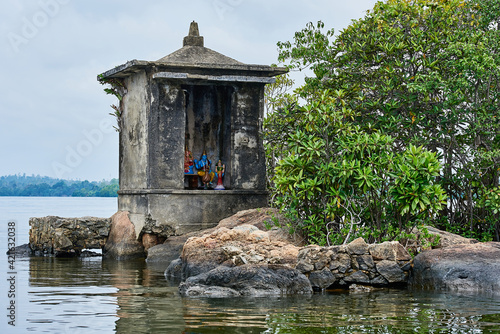 An old Buddha shrine on a tiny island in a lake