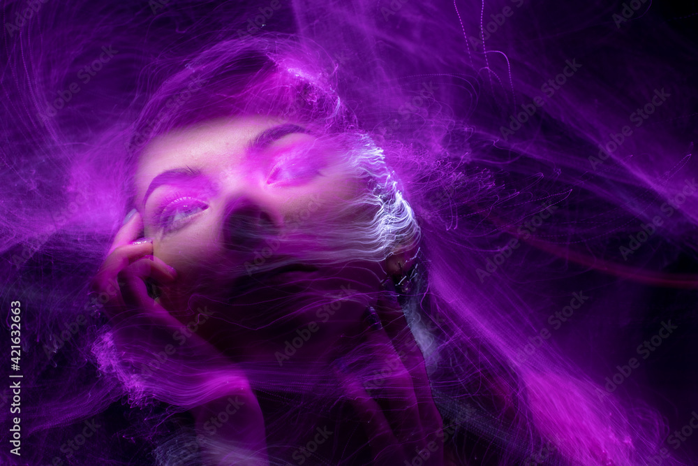 beautiful girl model with cosmic make-up on face, blue and purple color on dark background , longexposure foto beautiful girl model with cosmic make-up on face, blue and purple color on dark background , longexposure foto