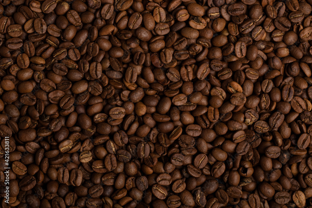 Fragrant grains of fried coffee. Background, texture