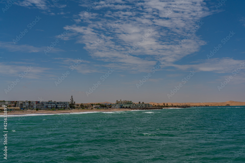 View from the jetty to Swakopmund city, Namibia, Africa, background blue sky and dunes
