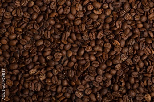 Fragrant grains of fried coffee. Background  texture